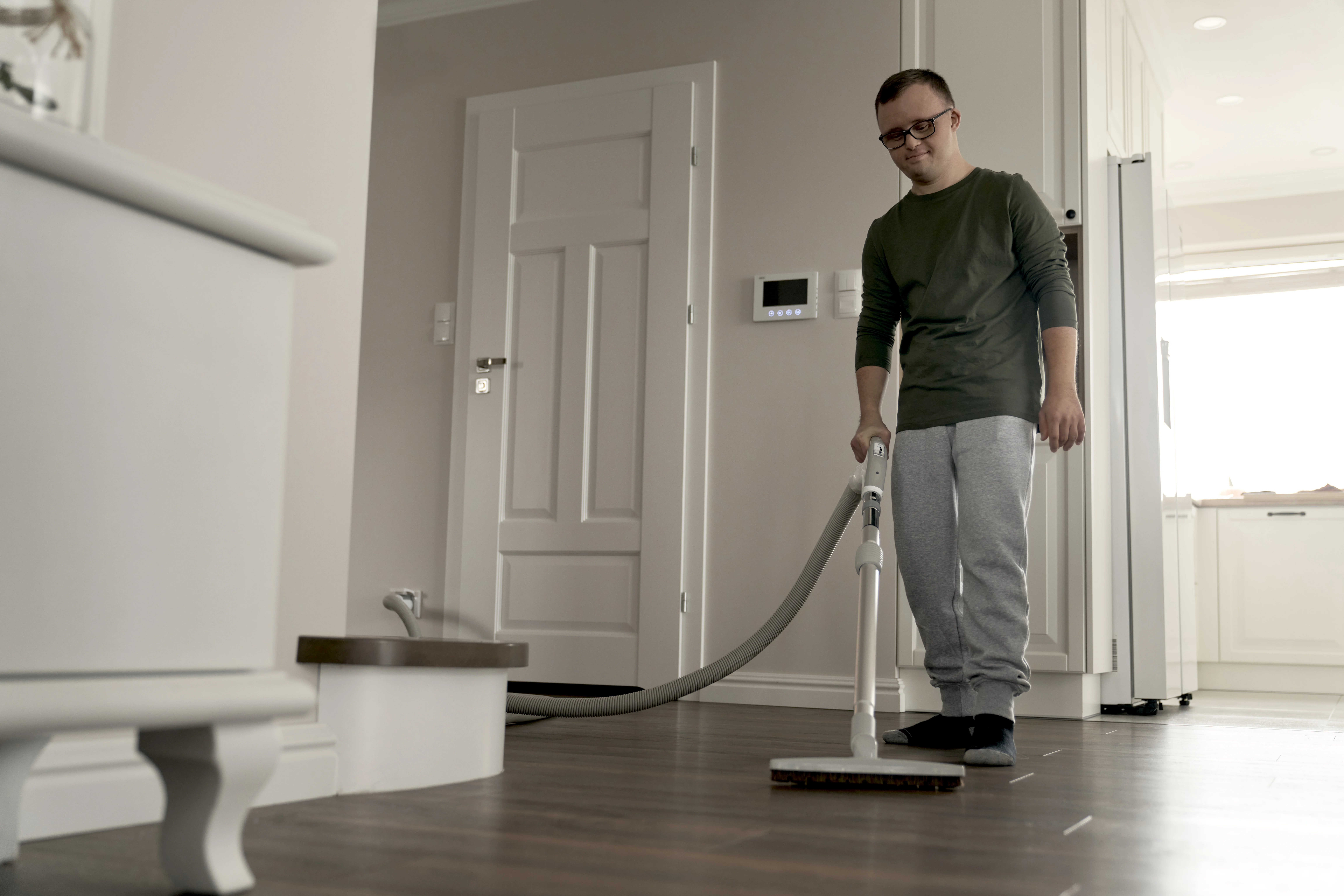 Homeowner using a Cana-Vac central vacuum system installed by Speedy Electric